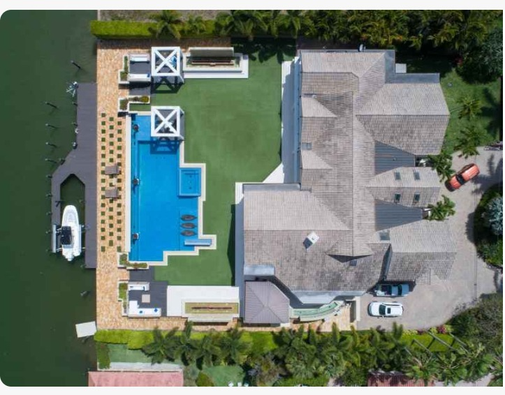 Overhead view of home showing rented boat dock with a boat in the slip